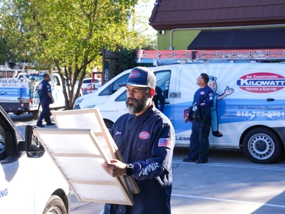 Technician holding air filters