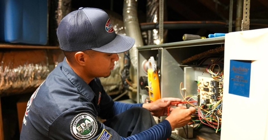 Technician troubleshooting a furnace