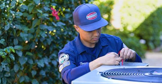 Kilowatt technician performing AC maintenance