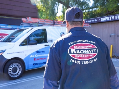 Technician walking to the work van.