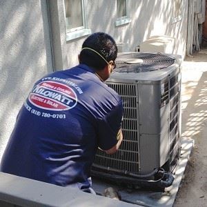 Team Member Working on AC Unit